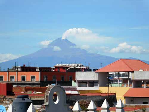 A view of Popocatépetl volcano smoking, from the rooftop terrace of our hotel